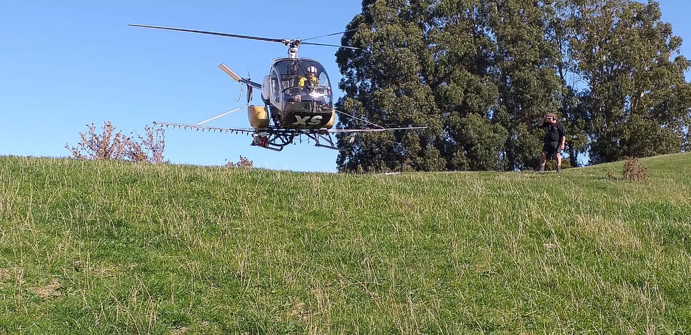 HXS, our Hughes 300C, equipped for spraying over Wairarapa farmland