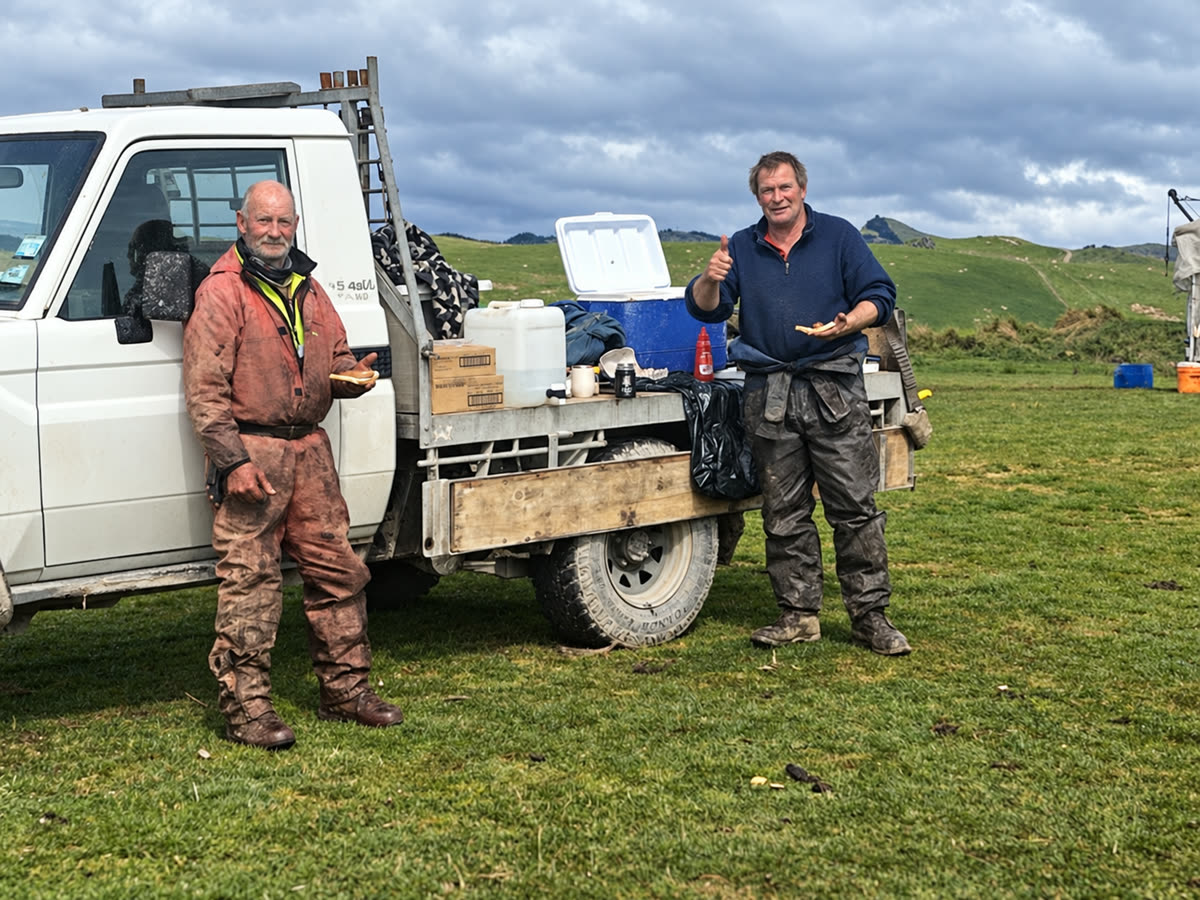 Tim and Custy enjoying a sandwich beside the farm truck in the Wairarapa